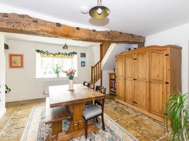 French doors open to the open plan kitchen/diner/living space with windows overlooking the rear garden, Oulton Hall Golf course and woodlands.