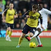 LIVELY: Leeds United loanee Lewis Bate gets away from Arsenal and England star Bukayo Saka in Monday night's third round FA Cup clash between his loan side Oxford United and the Gunners at the Kassam Stadium. Photo by Catherine Ivill/Getty Images.