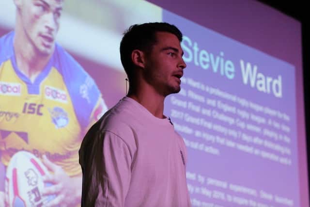 Stevie Ward is now a keynote speaker. Picture is him delivering a speech at his former school, Woodkirk High School.