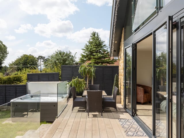 A decked terrace with glass balustrade extends the facilities from which to enjoy the panoramic views.