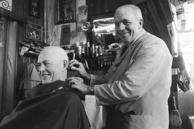 Tom Winterbottom who had been a barber for 54 years is pictured cutting the hair of customer Martin Roche in January 1985.  The 67-year-old whose shop was on Wellington Road in town started work as a lather boy earning seven shillings a week  for preparing men for shaves from 8 am to 8 pm and graduated to a fully fledged barber after years of training. He believed in offering good value with a flat rate of 90p for all haircuts.
