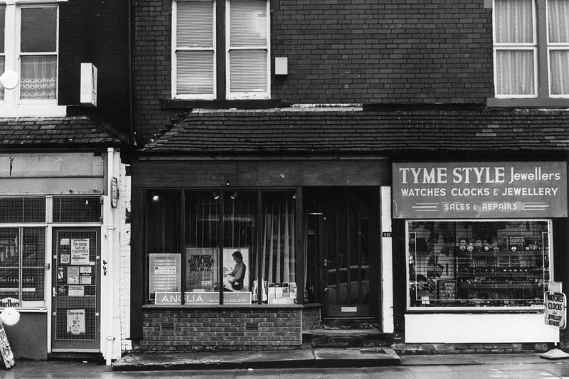 Harehills Lane in March 1982 showing part of a row of shops. On the right is Tyme Style Jewellers, then in the centre is the Anglia Building Society while on the left is a newsagent.