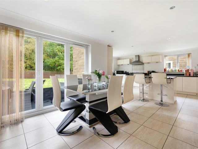 The dining area provides a perfect setting for entertaining, with large windows that flood the room with natural light and offer picturesque views of the garden with access out.
