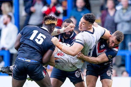 Tyler Dupree is tackled by Rhinos' Justin Sangare (number 15) - along with Samisoni Langi and Mickael Goudemand - during England's Test win over France last week. Picture by Allan McKenzie/SWpix.com.