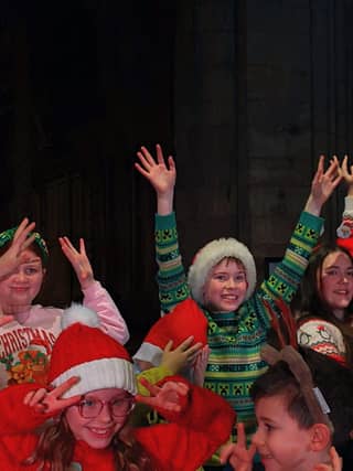 Young performers from PQA Leeds North & Bardsey and PQA Leeds East on stage for their Christmas performance with Nadia Eide.