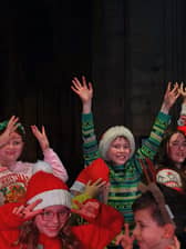 Young performers from PQA Leeds North & Bardsey and PQA Leeds East on stage for their Christmas performance with Nadia Eide.