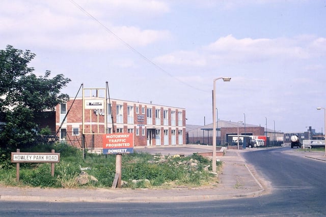 Howley Park Road and the entrance to Howley Park Trading Estate pictured in June 1970. At this time the M62 Lancashire-Yorkshire motorway was just being built. The largest building in the photograph is a warehouse for DCL (Distillers Company Limited).