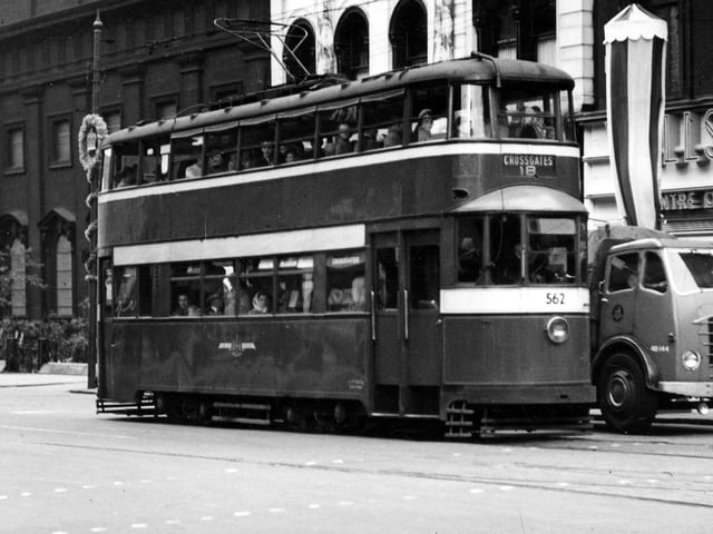 Boar Lane in June 1953 showing tram no.562, one of the Felthams acquired from London in 1950, travelling on route 18 to Crossgates. In the background are, on the right, Willson's Centre of Fashion and on the left, Holy Trinity Church. Decorations are up to celebrate the coronation of Queen Elizabeth II which took place on that date.