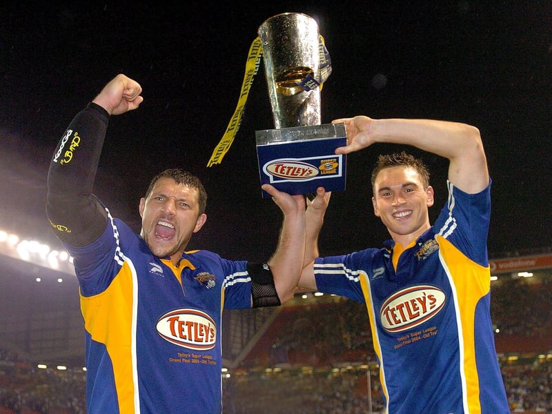Barrie McDermott and Kevin Sinfield celebrate with the Super League trophy.
