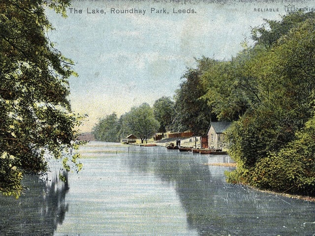 A colour-tinted postcard with a postdate of May 13, 1905, showing Waterloo Lake at Roundhay Park with the boathouse and landing stage in the background.