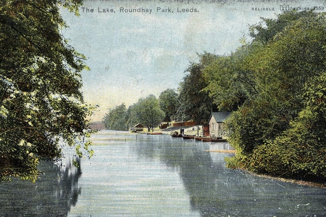 A colour-tinted postcard with a postdate of May 13, 1905, showing Waterloo Lake at Roundhay Park with the boathouse and landing stage in the background.