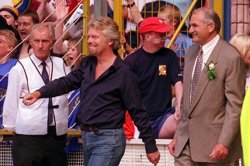 Broncos owner Richard Branson, left, leads his team out, alongside the more smartly-dressed Rhinos chairman Paul Caddick.