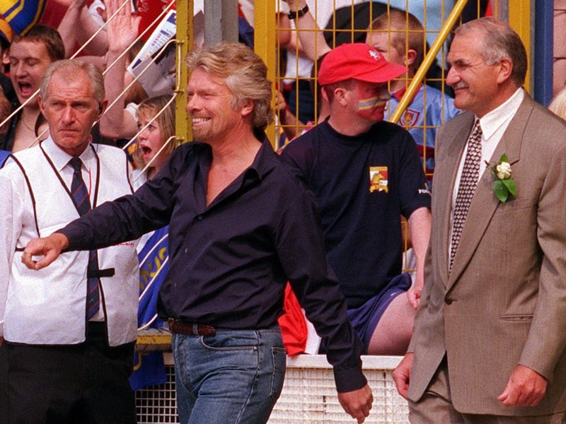 Broncos owner Richard Branson, left, leads his team out, alongside the more smartly-dressed Rhinos chairman Paul Caddick.