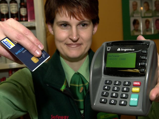 Safeway checkout manager Sam Robins, pictured with the new chip and pin machine at their city centre store on February 12, 2004.