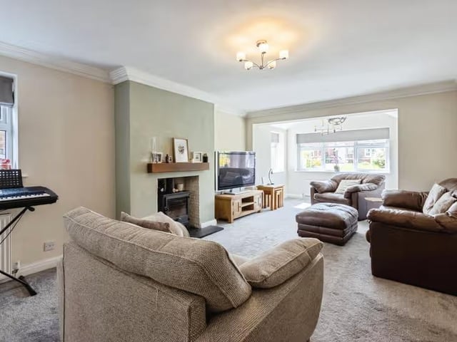 The ground floor also offers a spacious lounge with log-burning stove.