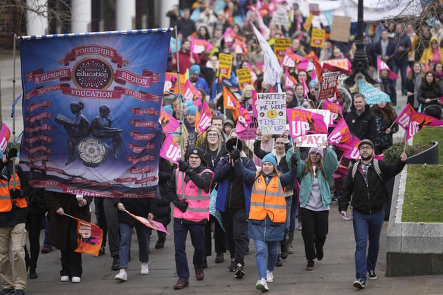 The striking teachers and their supporters march through Leeds city centre.