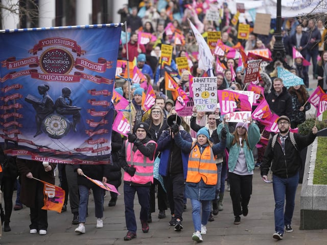The striking teachers and their supporters march through Leeds city centre.