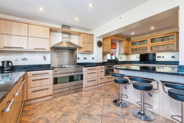 The kitchen/breakfast room has underfloor heating, quartz work surfaces and a breakfast bar with a wine rack.