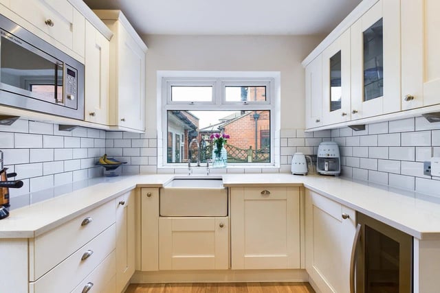 The kitchen is fitted with shaker style base wall units, quartz worktops, a Belfast sink, with space provided for a range cooker and an American-style fridge freezer.