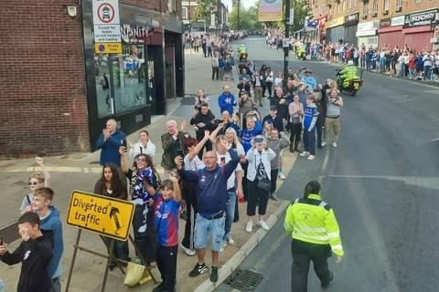 Fans line the route.