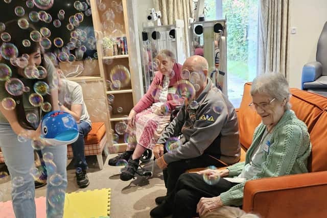 Residents at HC-One’s Colton Lodges Care Home with children from Songs & Smiles baby group
