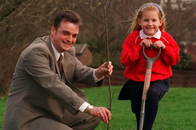 Young Gildersome Primary pupil Fiona Husker plants a tree in the school grounds watched by John Pygott, Fisheries, Recreation, Conservation and Navigation Manager for the Environment Agency. Pictured in April 1996.