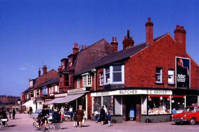 Wyther Park parade of shops in April 1969. R.C. Groves, butchers, is on the corner with Wyther Park Mount. Looking along the parade, Frank Slights greengrocers is next followed by Wyther Park Bakeries, Chapman's Newsagents, Boots the Chemist, a haberdashers, an ironmongers, a Post Office and a betting shop. The advertising poster on the gable end states 'Aztec, a chocolate feast from Cadbury's'.