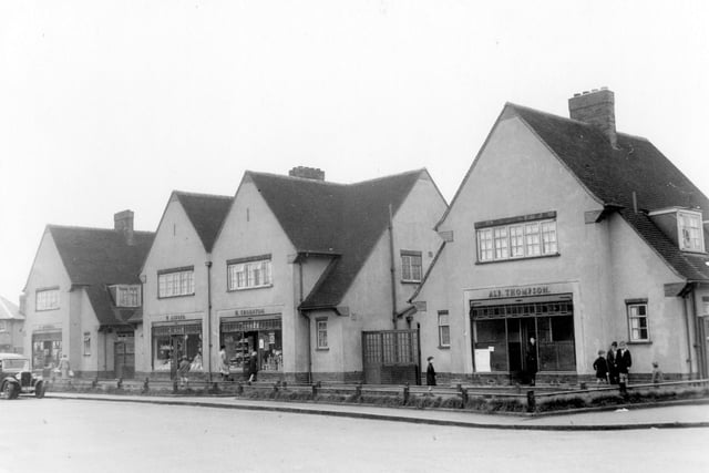 A parade of shops on Sissons Avenue with living accommodation pictured in August 1939. On the left is number 28, C. Mitchell, butcher. Moving right, number 26 Willie Aldred green grocer. Next to number 24 Harry Thornton grocer. Number 22 Alfred Thompson Fish & Chips. Shoppers and children can be seen.