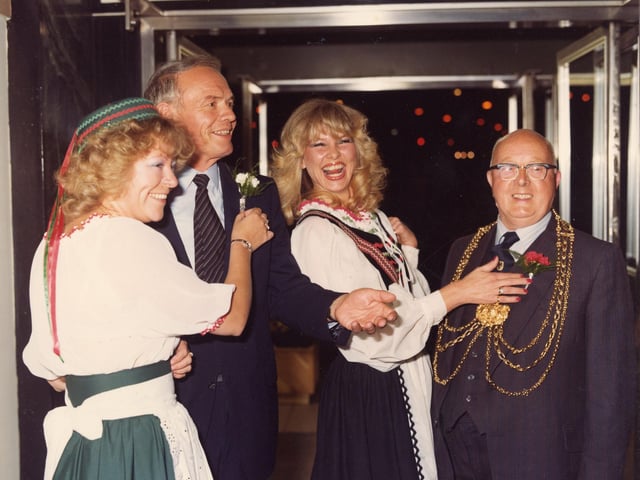 The Lord Mayors of the twinned cities of Leeds and Dortmund are receiving carnation boutonnieres from two ladies dressed in German national costume. This was at an evening event organised during Dortmund Week in the restaurant of Lewis's department store in the Headrow. Dortmund Week was held to celebrate 10 years of twinship between Leeds and Dortmund. The Lord Mayor of Dortmund, or Oberburgermeister, Gunter Samtlebe is on the left and the Lord Mayor of Leeds, Councillor Eric Atkinson MBE is seen, right. Pictured in September 1980.