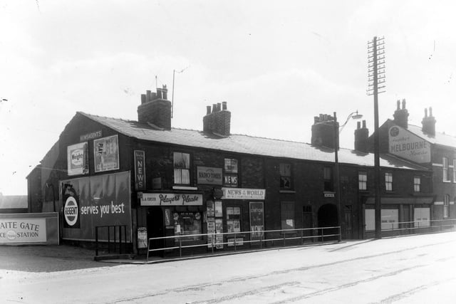 Thwaite Gate showing on the left of the image an entrance to the forecourt of the Thwaite Gate Service Station. Next to this is D & A Forster, newsagents. Pictured in July 1959.