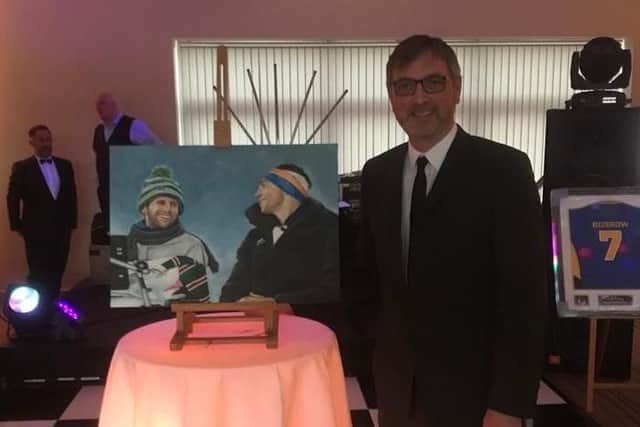 Brent Sheldon with one of his paintings of Rhinos legends Rob Burrow and Kevin Sinfieldf. Picture by  Brent Sheldon.