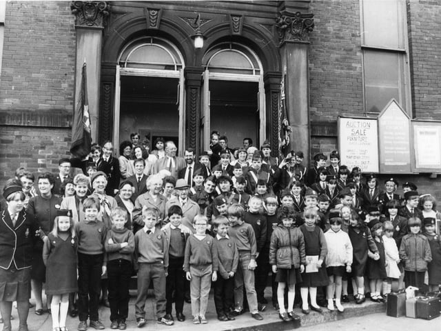 Members of the congregation of Upper Armley Methodist Church gathered together for the final service held on Sunday, May 10, 1987. The church was to be demolished and rebuilt as a Community Centre with £213,000 funding via an Urban Programme grant. In the centre, towards the back, is the Minister of the Church, Reverend Gordon Lister, with Councillor John Battle, Chair of the Council's Urban Development Committee. Also in the picture are representatives of the Girls' and Boys' Brigades. The new centre was to include a luncheon club, a playgroup, adult education classes, a credit union and an advice and counselling service for families. Upper Armley Methodist Church was built in brick in the Italian style and dated from 1878.