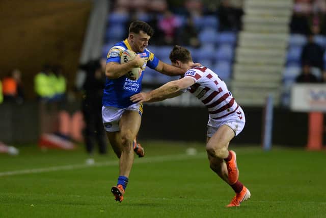 Liam Tindall is tackled by Jai Field in Rhinos' Super League defeat at Wigan seven months ago.  Picture by Bruce Rollinson.