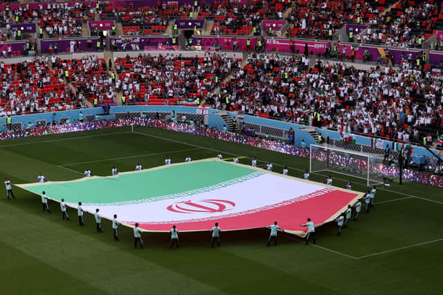 DOHA, QATAR - NOVEMBER 25: A giant flag of IR Iran on the pitch prior to the FIFA World Cup Qatar 2022 Group B match between Wales and IR Iran at Ahmad Bin Ali Stadium on November 25, 2022 in Doha, Qatar. (Photo by Catherine Ivill/Getty Images)