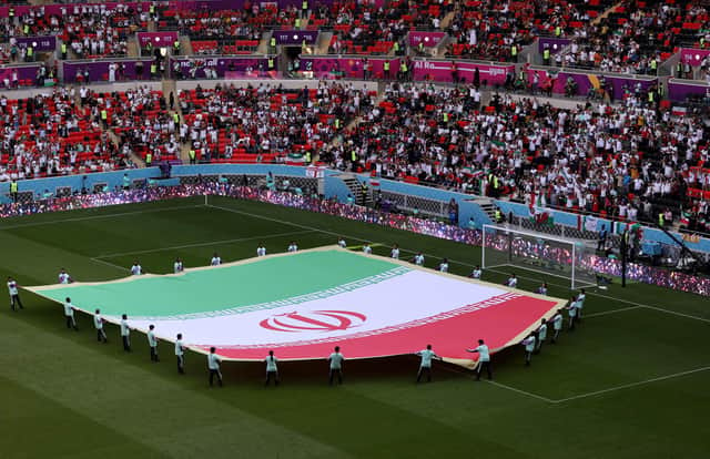 DOHA, QATAR - NOVEMBER 25: A giant flag of IR Iran on the pitch prior to the FIFA World Cup Qatar 2022 Group B match between Wales and IR Iran at Ahmad Bin Ali Stadium on November 25, 2022 in Doha, Qatar. (Photo by Catherine Ivill/Getty Images)
