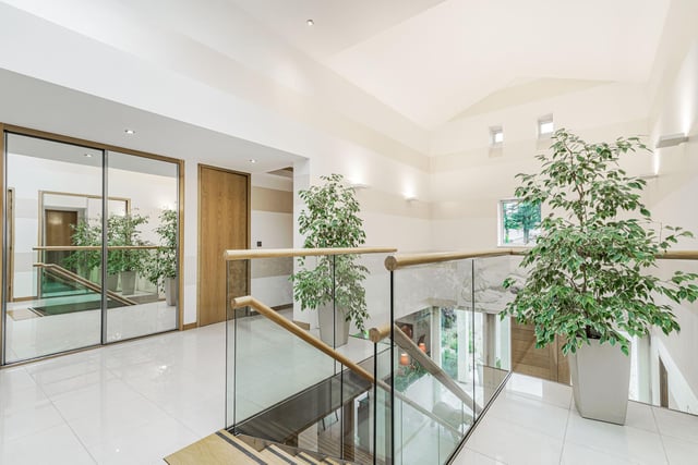 A grand central staircase leads to all the principal reception rooms. There is a study with fitted furniture which gives access to a laundry and guest W.C, and a dining kitchen with a utility attached.