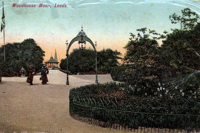 Colour-tinted postcard of Woodhouse Moor with a postmark of April 1907. In the centre is one of the ornamental lamp arches that lit up the park at night. A footpath leads to the Bandstand in the background.