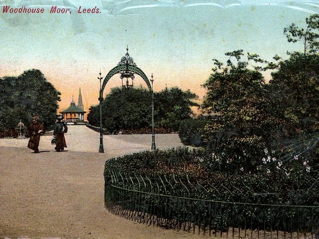 Colour-tinted postcard of Woodhouse Moor with a postmark of April 1907. In the centre is one of the ornamental lamp arches that lit up the park at night. A footpath leads to the Bandstand in the background.