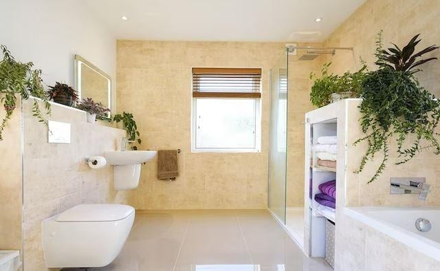 The generous house bathroom with bath and shower cubicle and underfloor heating.