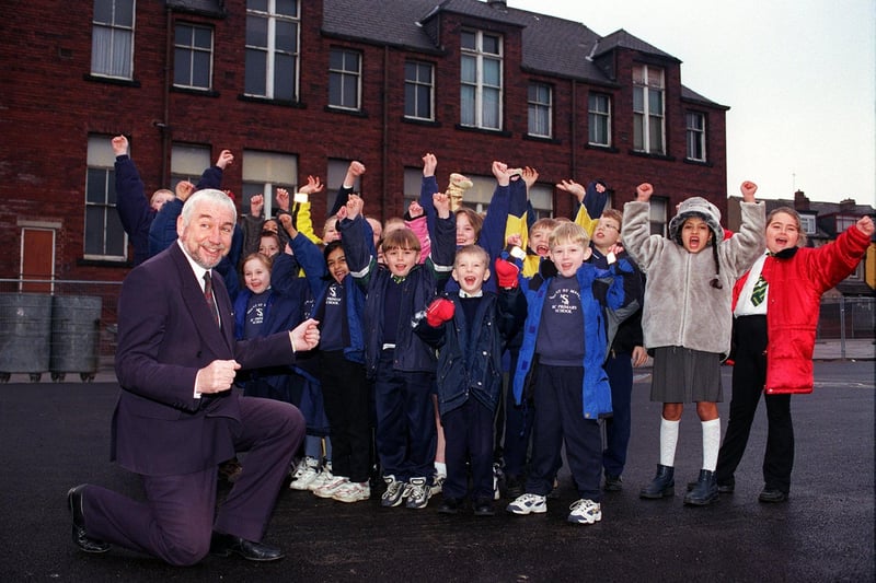 Head teacher Martin Flannery with children from Year's 1, 2 and 4 in the playground of Mount Saint Mary's Primary on Raincliffe Road in December 1999. The school community was celebrating after being awarded £40,000 to rebuild the school.