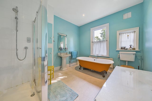 The family bathroom includes a period claw-foot bath, a large walk-in shower enclosure with a plumbed shower, low level WC and a period pedestal washbasin.