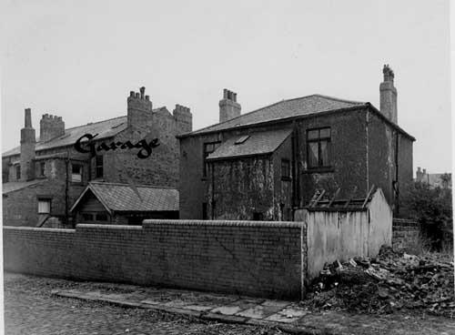 A rear view of the premises of Dorley Fireplace Company on Louis Street in November 1947. This view is from Back Francis Street. This stretch of Louis Street and Back Francis Street is situated between Frankland Place and Hamilton Place. The garage is labelled by the City Engineers' Department. In the background left are the backs of three terraced properties numbering 63 to 67 Louis Street. They stand at the junction with Frankland Place.