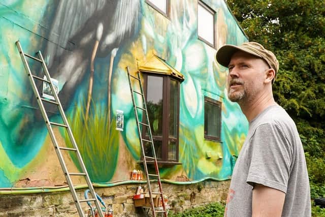 Street artist Ralph Replete puts the finishing touches to the Heron mural at Meanwood Valley Urban Farm. Picture: Simon Dewhurst.