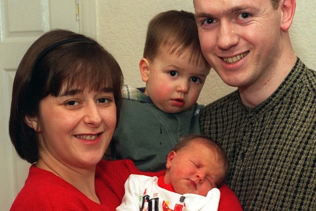 Gildersome paramedic Andy Bolton who delivered his own daughter. He is pictured with wife Maxine, son Jonathan with baby Amanda.  Pictured in March 1997.