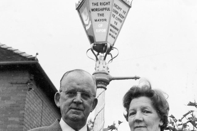 Alderman and Mrs. W. R. Beaumont, Mayor and Mayoress of Ripon, in front of the Mayor's street lamp, set up according to a Ripon custom - in the garden of their home on Whitcliffe Lane.