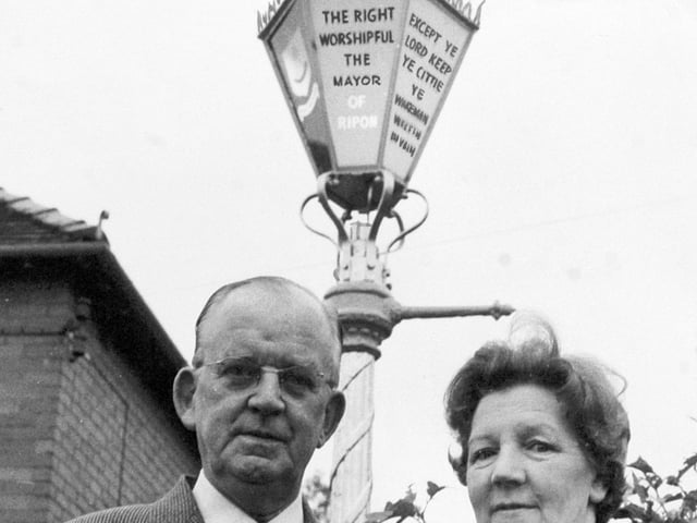 Alderman and Mrs. W. R. Beaumont, Mayor and Mayoress of Ripon, in front of the Mayor's street lamp, set up according to a Ripon custom - in the garden of their home on Whitcliffe Lane.