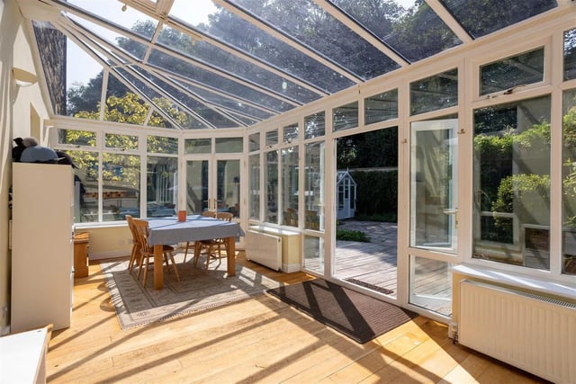 The larger conservatory is being used as a utility and crafting room by the current owners.
