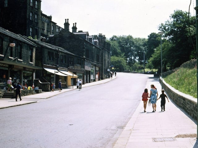 Looking up Scatcherd Hill, Queen Street, from the traffic lights. The road and particularly the pavement on the right hand side have been widened after the demolition of the buildings there, but the display of bulbs and shrubs has not been started. The shops at the left hand side have not been cleaned as yet and traffic still seems rather sparse while there are still no double yellow lines.