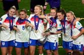 Alessia Russo, Georgia Stanway, Leah Williamson, Keira Walsh, Ella Toone and Beth Mead with the UEFA Women's Euro trophy.