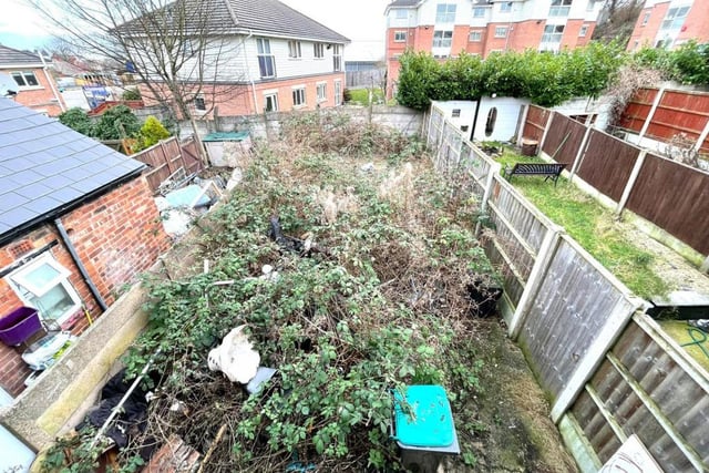 This is the view from the second bedroom of the back garden. It's overgrown and unkempt now, but it's also a sizeable space that could be part-utilised for an extension, subject to planning permission.